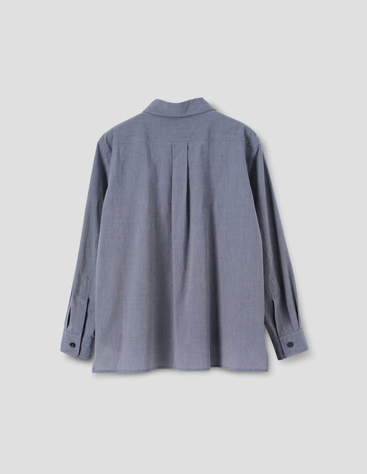 Blue cotton shirt with pleat on back yoke, mother of pearl buttons cuffs and stepped hem. Back flat lay view.