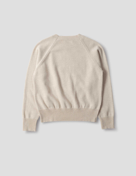 Light beige merino cashmere jumper with fully fashioned raglan sleeves with ribbed cuffs and ribbed hem. Back flat lay view.