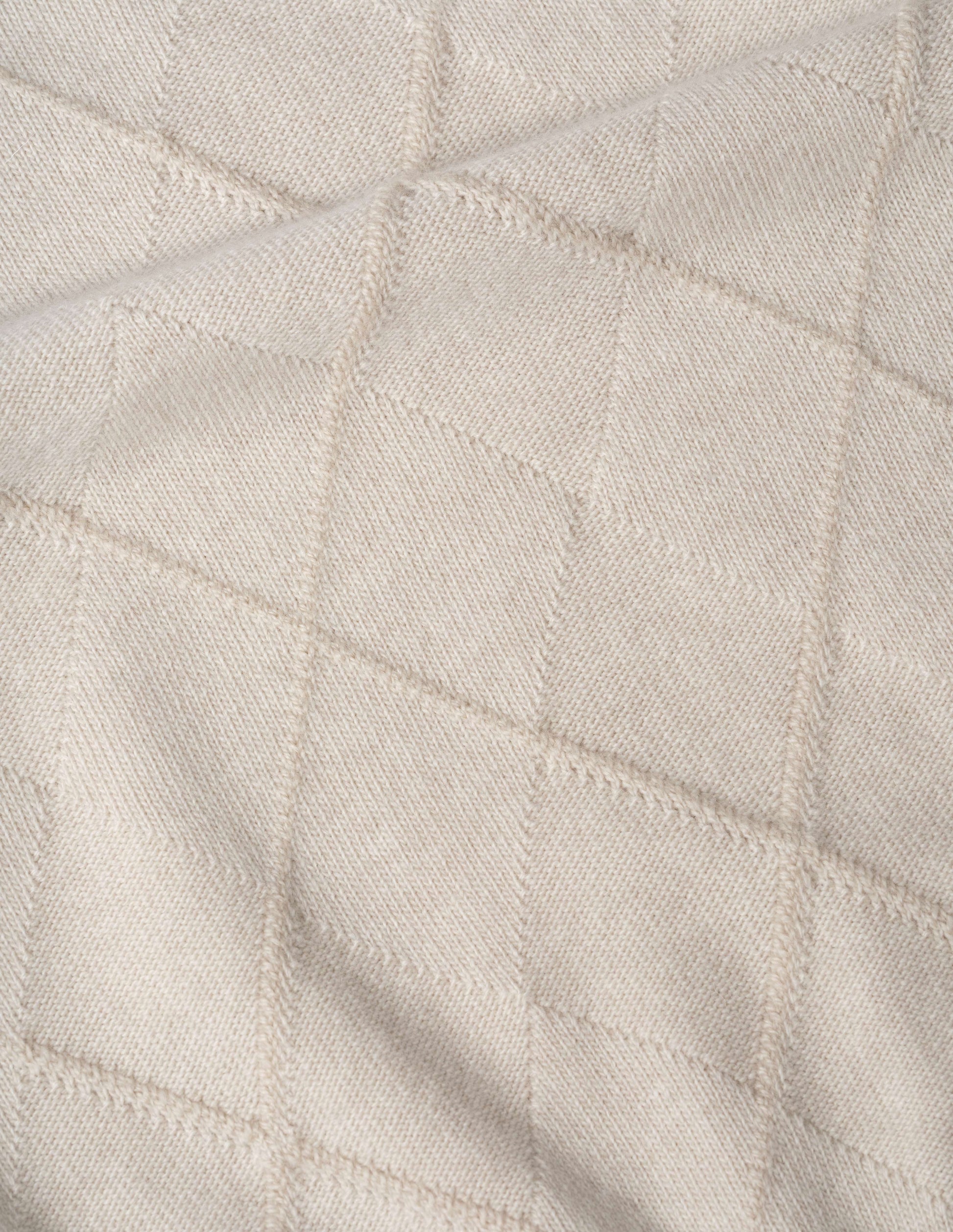 Light beige merino cashmere jumper fabric swatch.