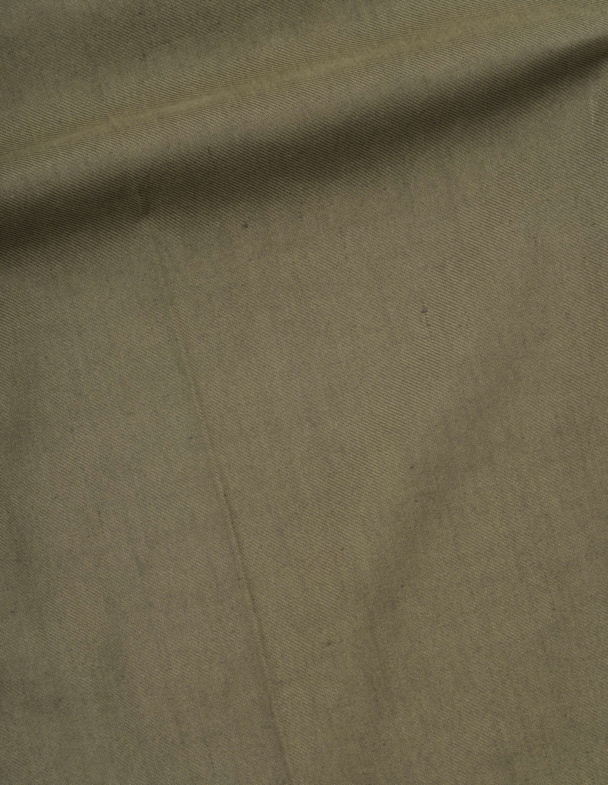 Green cotton linen twill trousers fabric swatch.
