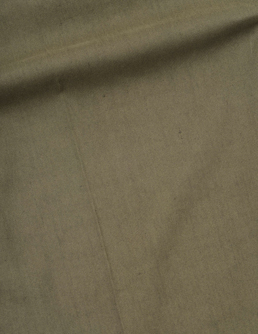 Green cotton linen twill trousers fabric swatch.