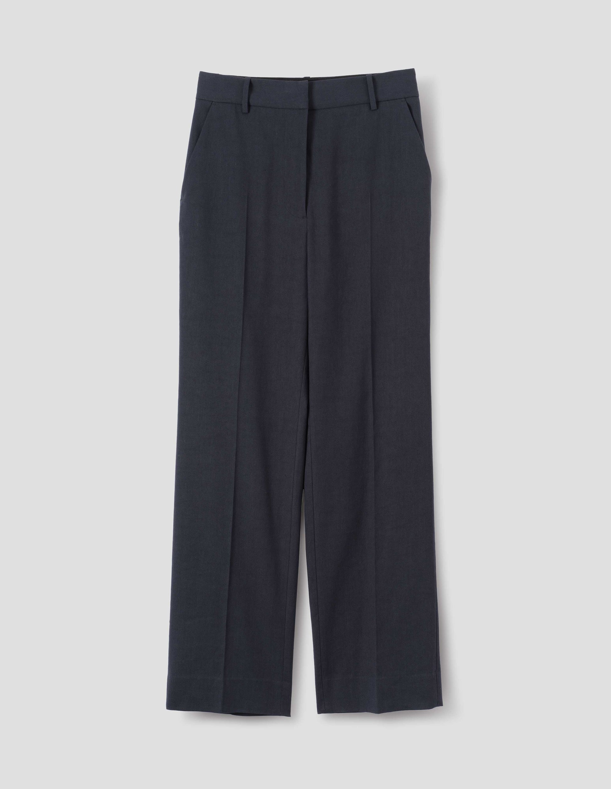 Dark blue cotton linen trousers with belt loops and slant pockets. Front flat lay view.
