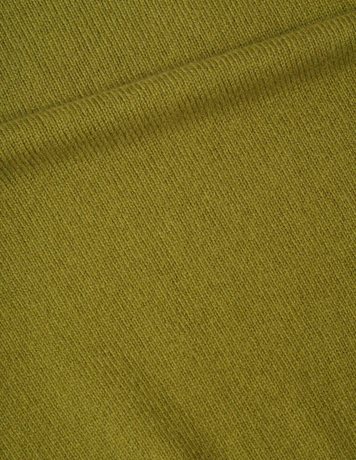 Green cashmere jumper fabric swatch.