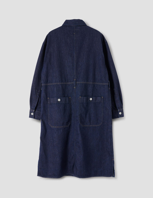 Indigo blue denim twill shirt dress with waist seam detailing with belt loops, side split hem, shirt cuffs with metal buttons and patch pockets on back skirt with metal buttons. Back flat lay view.