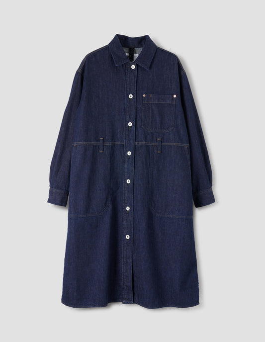 Indigo blue denim twill shirt dress with stitch through raised placket, patch pocket with pen pocket detail, slant through side pockets, waist seam detailing with belt loops, side split hem, shirt cuffs and metal button closure. Front flat lay view.