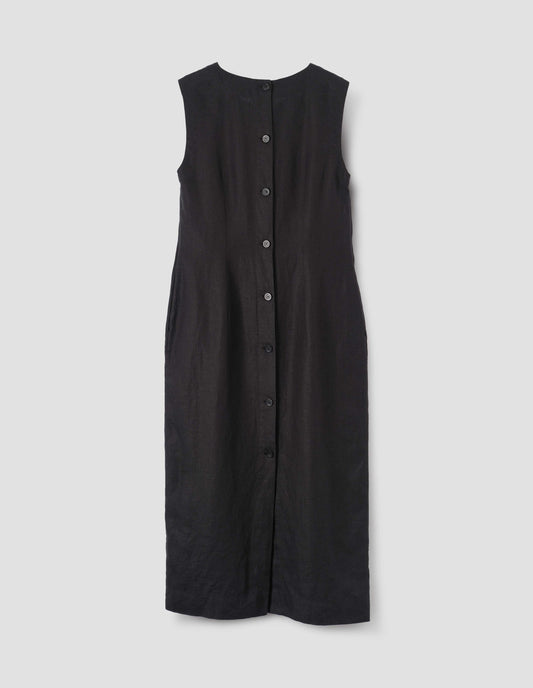 Black straight cut midi length sleeveless dress with horn buttons and back vent, back flat lay view.