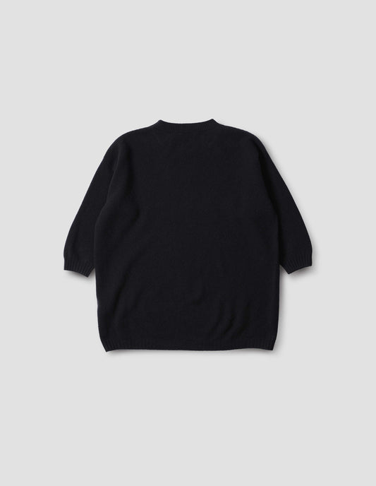 Dark blue crew neck jumper with cropped sleeves, back flat lay view.