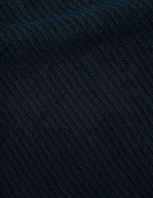 Dark blue knitted waistcoat soft spun wool fabric swatch.