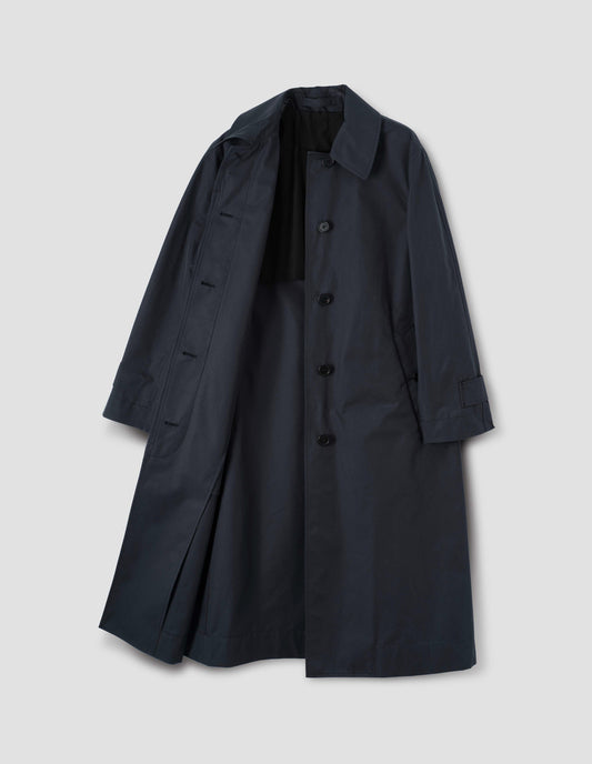 Navy blue long mac with button fastening, button welt pockets and button tab cuffs, front open flat lay view.