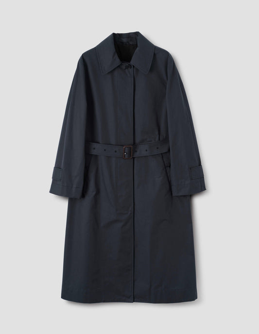 Navy blue long mac with button fastening, button welt pockets and button tab cuffs, with a detachable leather buckle belt, front flat lay view.