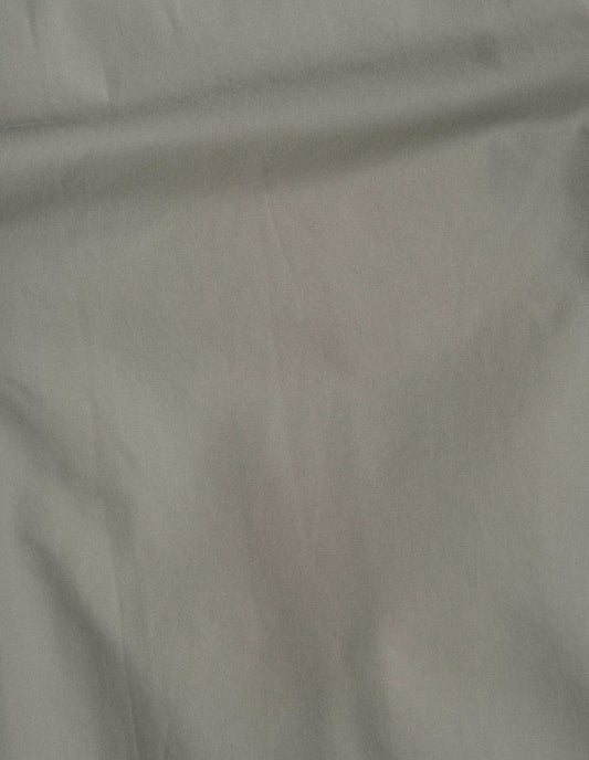 Beige/khaki proofed worn cotton twill fabric swatch. 
