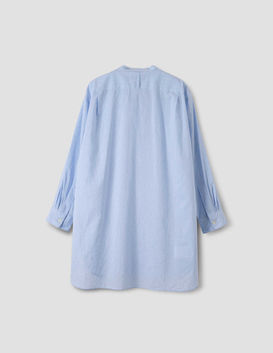 Blue longline collarless shirt with curved hem, back view.