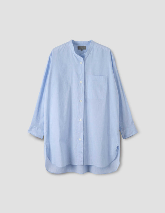 Blue longline collarless shirt with mother of pearl buttons and chest pocket, front view.