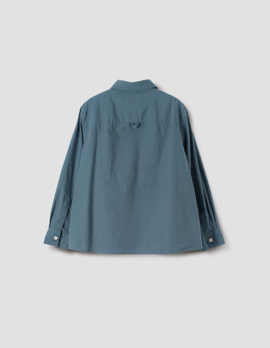 Blue long sleeve shirt, with corozo button cuffs and hanger loop on back yoke, back flat lay view.