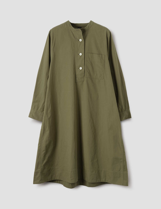 Green collarless swing dress with long sleeves, chest pocket and white corozo brace button fastening, front flat lay view.