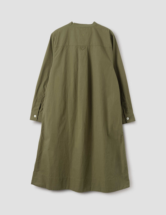 Green collarless swing dress with long sleeves, white corozo brace buttons on cuffs and hanger loop detail on back, back flat lay view.