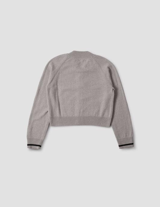Grey cropped length cardigan with raglan sleeve and contrast stripe on cuff, back flat lay view