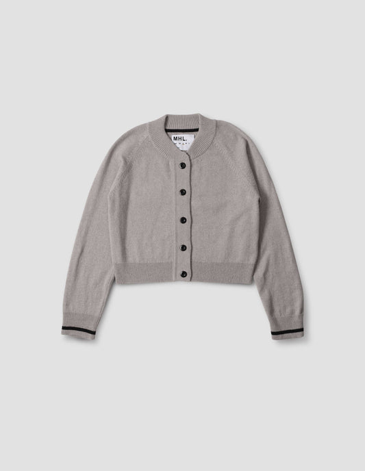Grey cropped length cardigan with raglan sleeve, black corozo brace button fastening, contrast stripe on cuffs, front flat lay view.