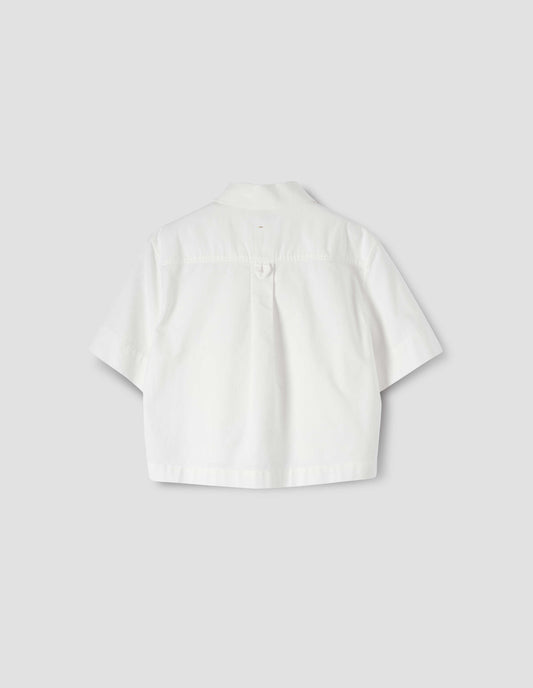 White cropped short sleeve shirt, with box pleat and hanger loop detail on back yoke, back flat lay view. 