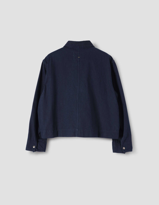 Indigo blue cropped jacket with press stud fastening cuffs, back flat lay view.