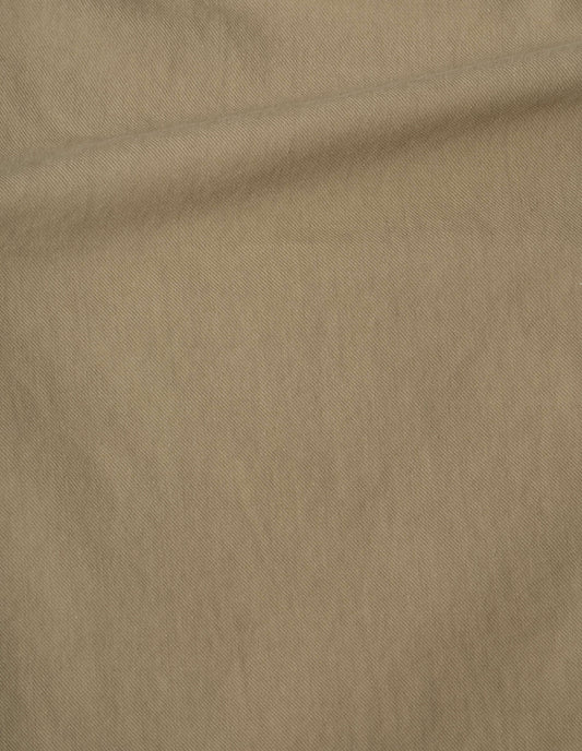Beige sleeveless shirt, irregular cotton drill fabric swatch. 