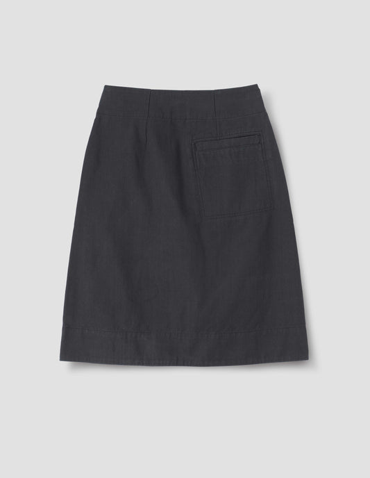 Dark blue skirt with welt back pocket, back flat lay view.