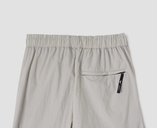 Light grey trousers with zip welt back pocket and elasticated waist, back flat lay view.