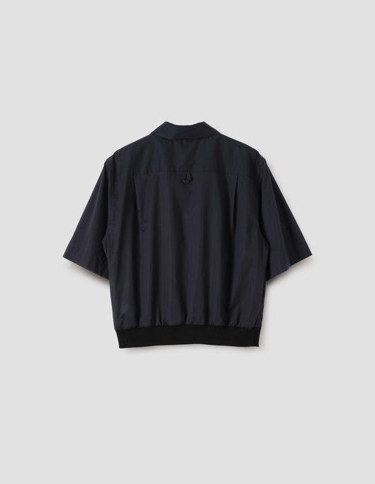 Black shirt with contrasting elasticated hem and hanger loop on back yoke, back view.