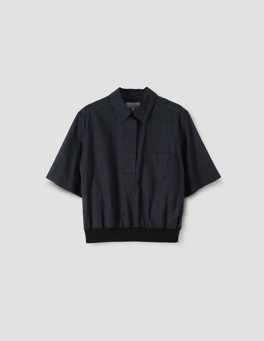 Black shirt with button fly fastening, chest pocket and contrasting elasticated hem, front view. 
