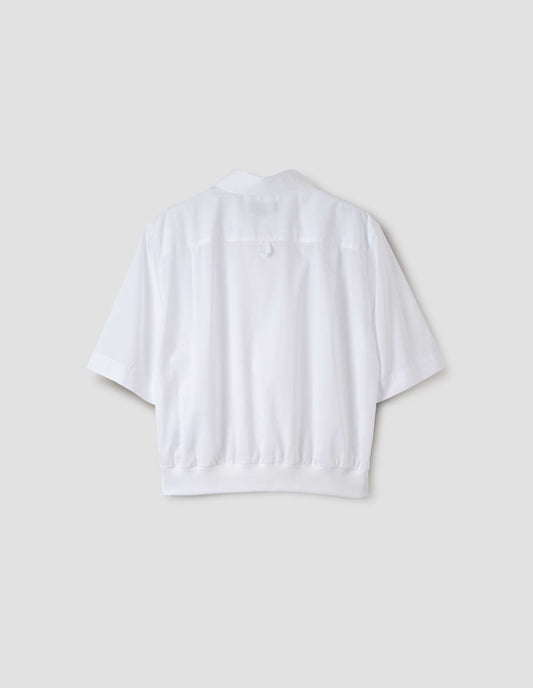 White shirt with contrasting elasticated hem and hanger loop on back yoke, back view.