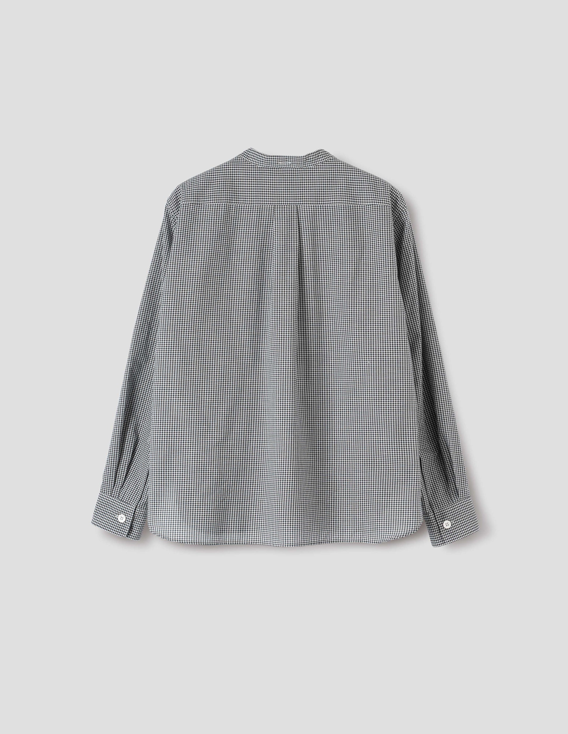 Black and white gingham cotton cashmere collarless long sleeve shirt, with mother of pearl button cuffs, box stitch detailing on back yoke and elongated hem. Back flat lay view.