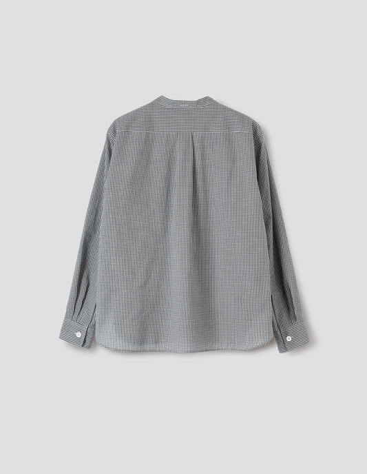 Black and white gingham cotton cashmere collarless long sleeve shirt, with mother of pearl button cuffs, box stitch detailing on back yoke and elongated hem. Back flat lay view.