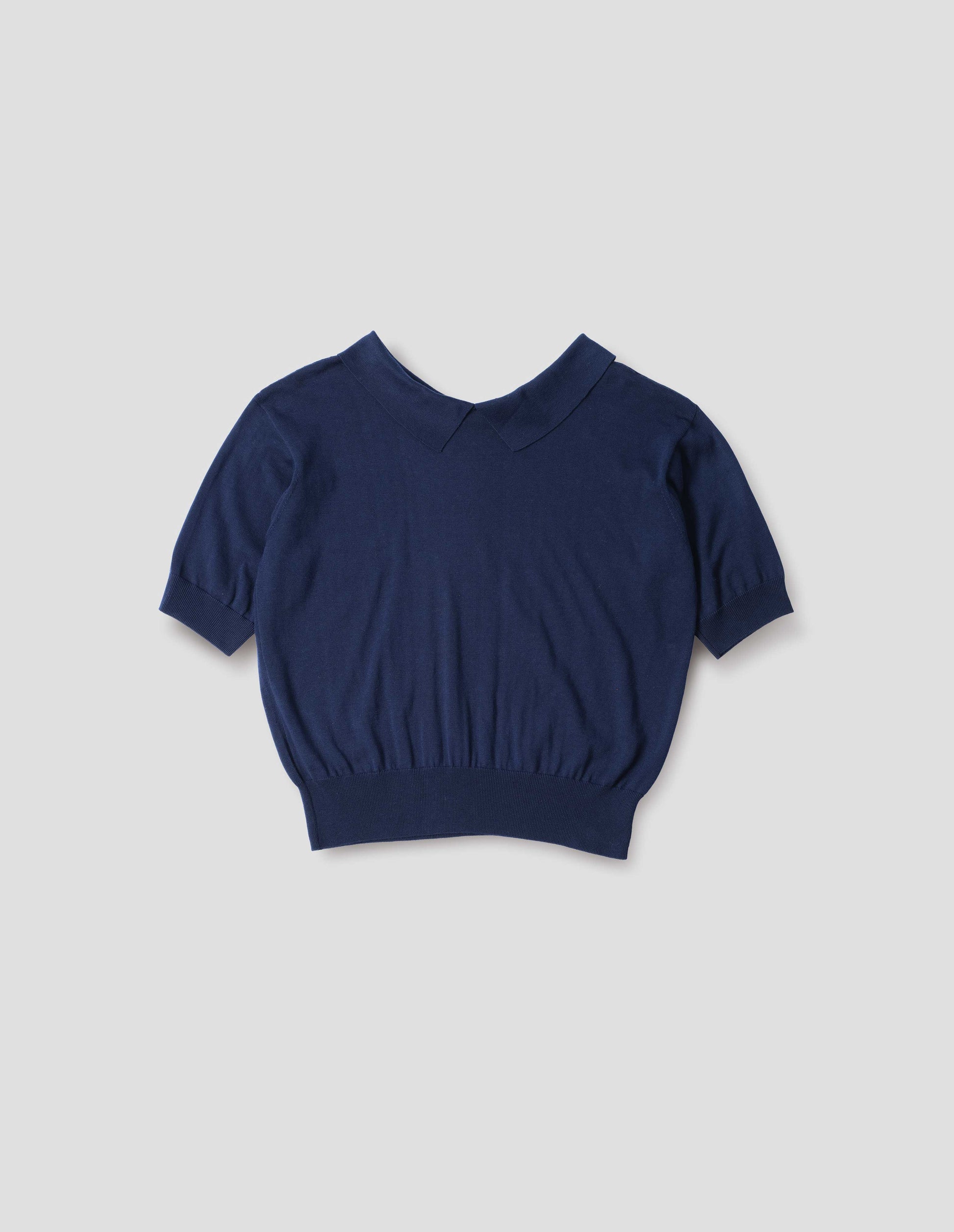 Dark navy cotton and linen knitted t-shirt, with cutaway collar and rib cuff and hem. Back flat lay view.