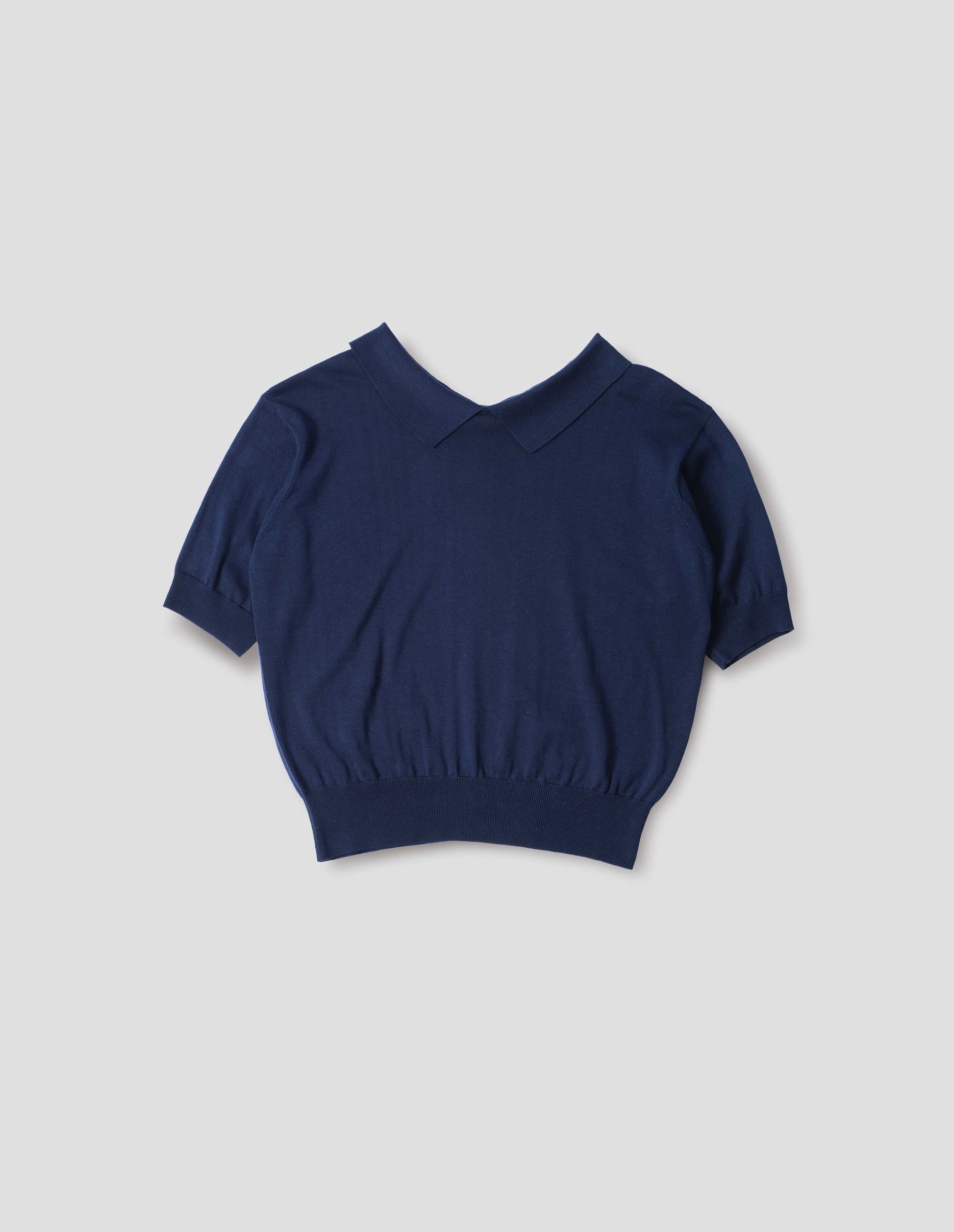 Dark navy cotton and linen knitted t-shirt, with cutaway collar and rib cuff and hem. Front flat lay view.