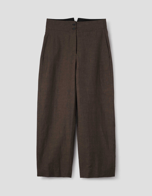 Brown cotton linen trousers, with deep waistband, double horn button closure and slant side pockets. Front flat lay view.