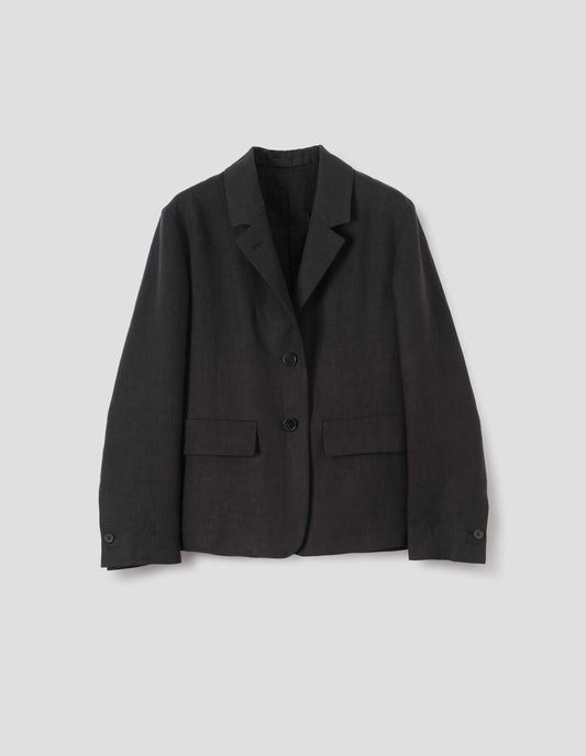 Black linen blazer with horn button fastening lapel, horn button cuffs and two flap concealed pockets. Front flat lay view.