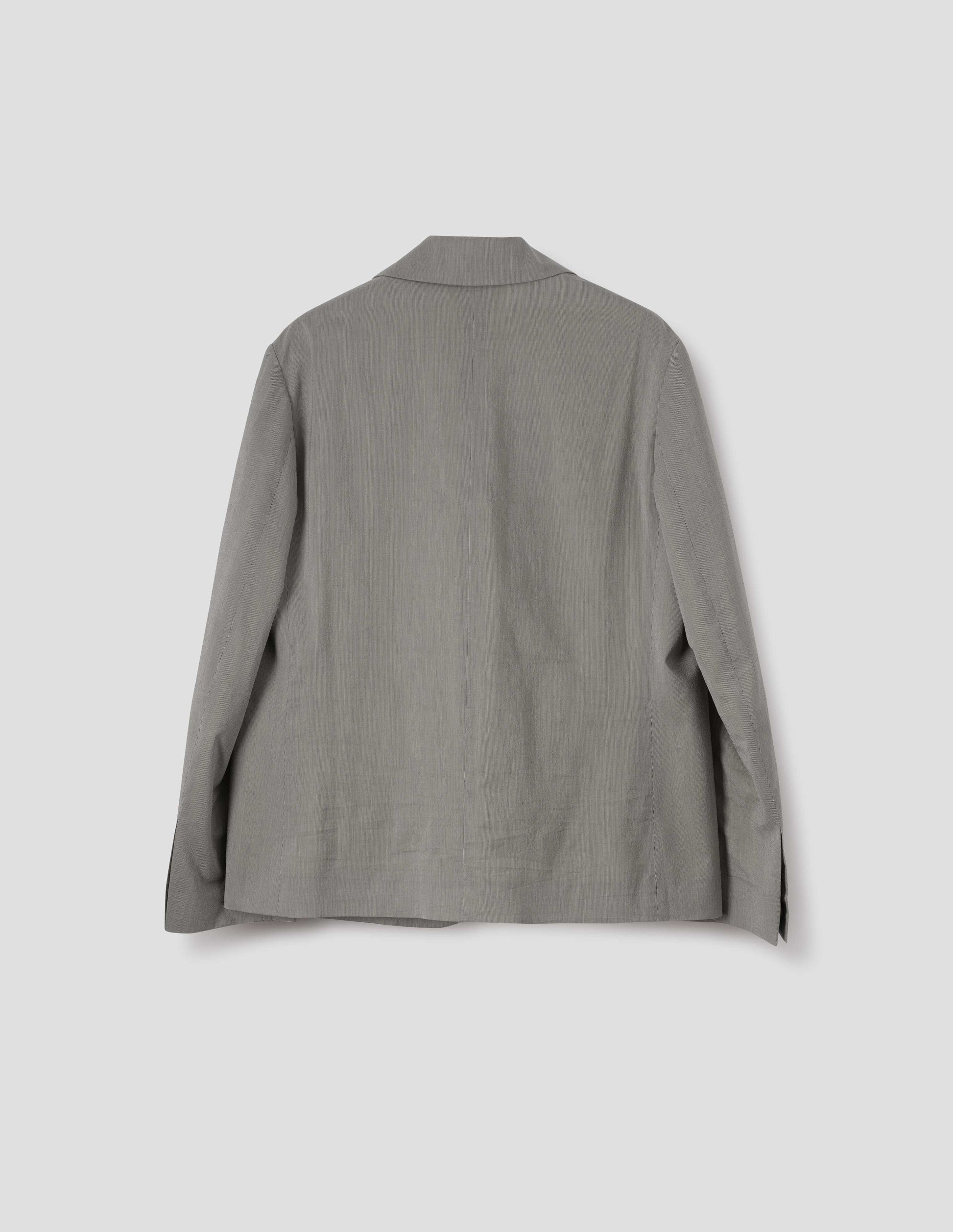 Black and cream stripe cotton silk blazer, with horn button cuffs. Back flat lay view.