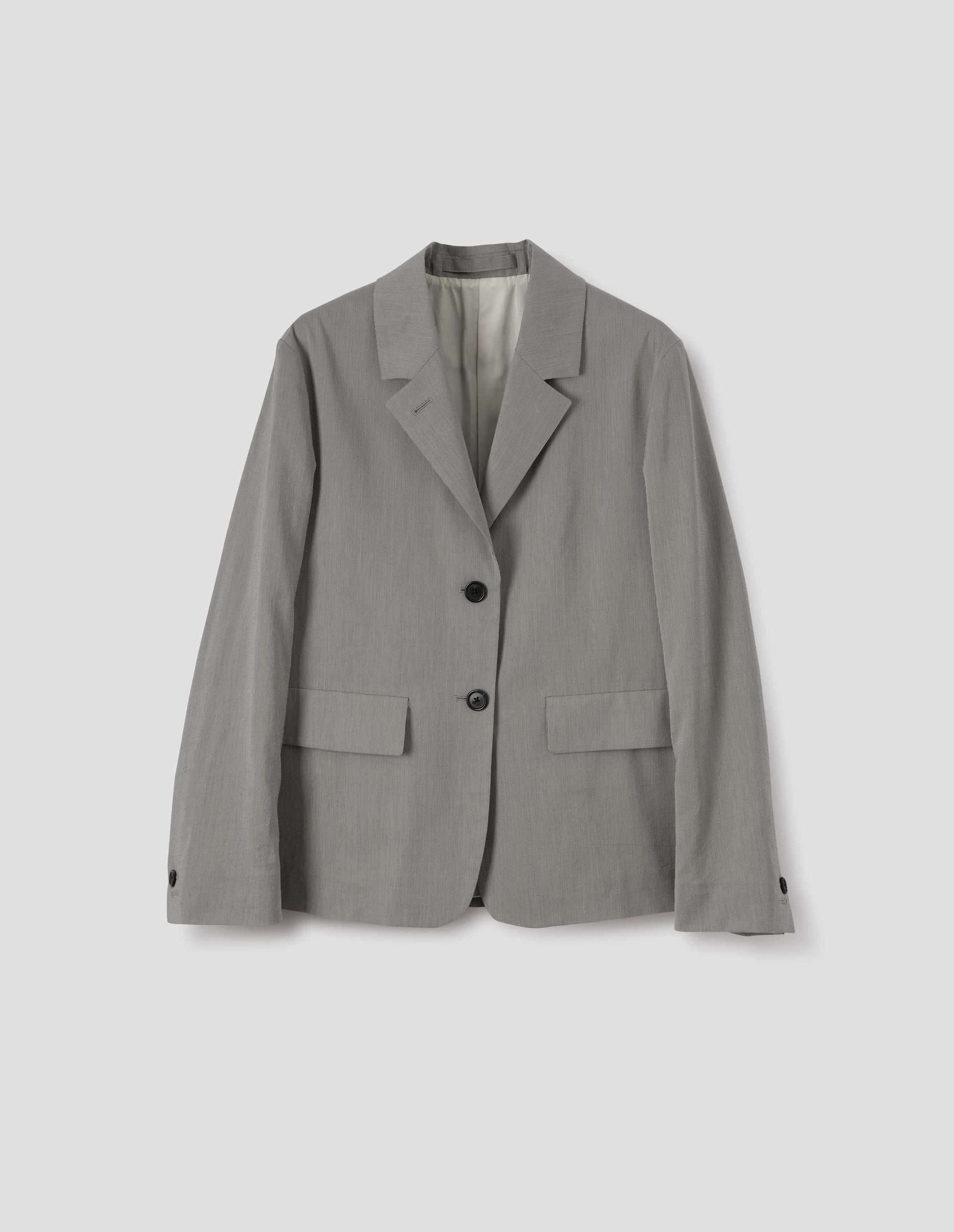 Black and cream stripe cotton silk blazer with horn button fastening lapel, horn button cuffs and two flap concealed pockets. Front flat lay view.