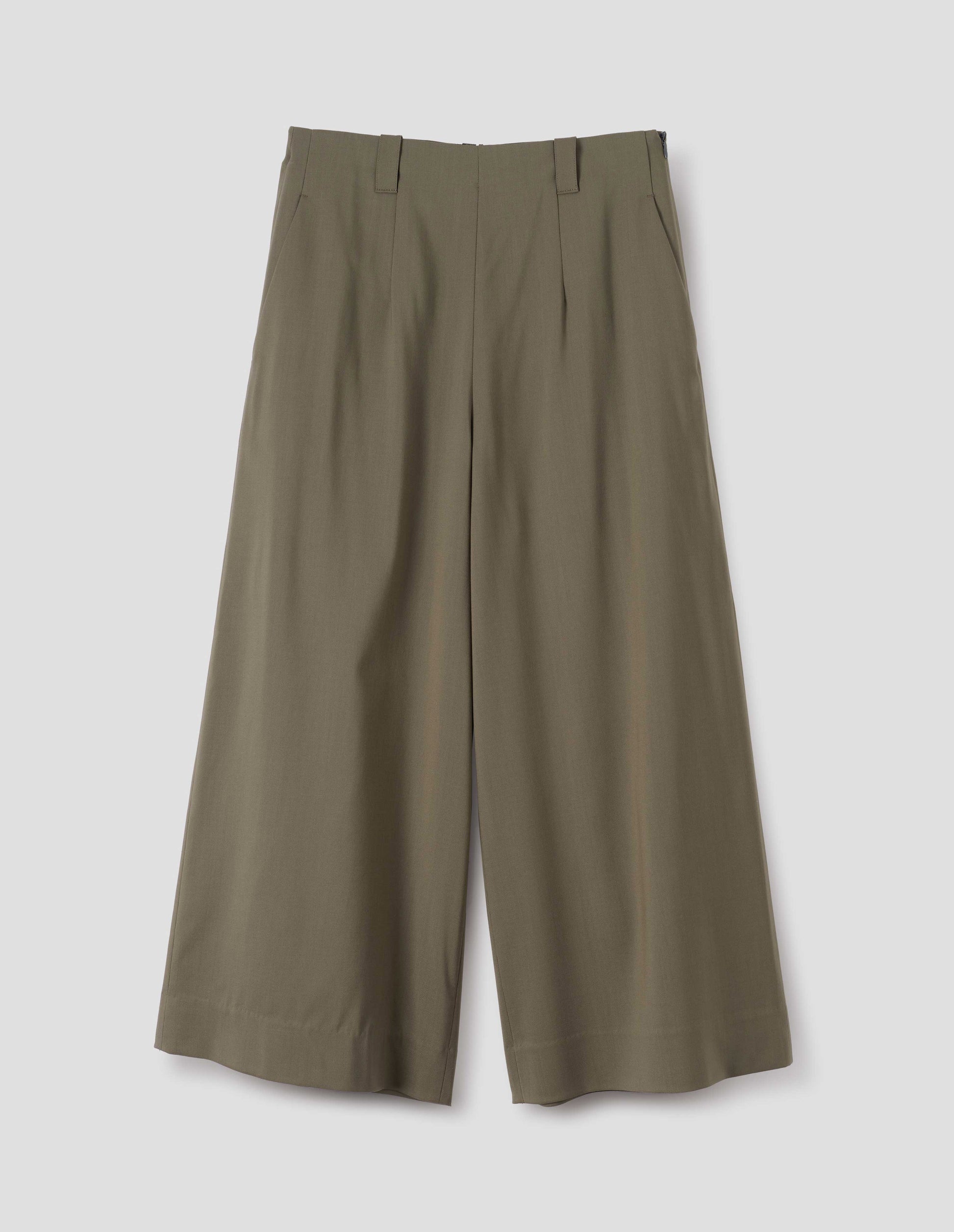 Brown wide leg culottes with grown-on waistband with belt loops, concealed side zip with horn button tab fastening, and slant pockets. Front flat lay view.