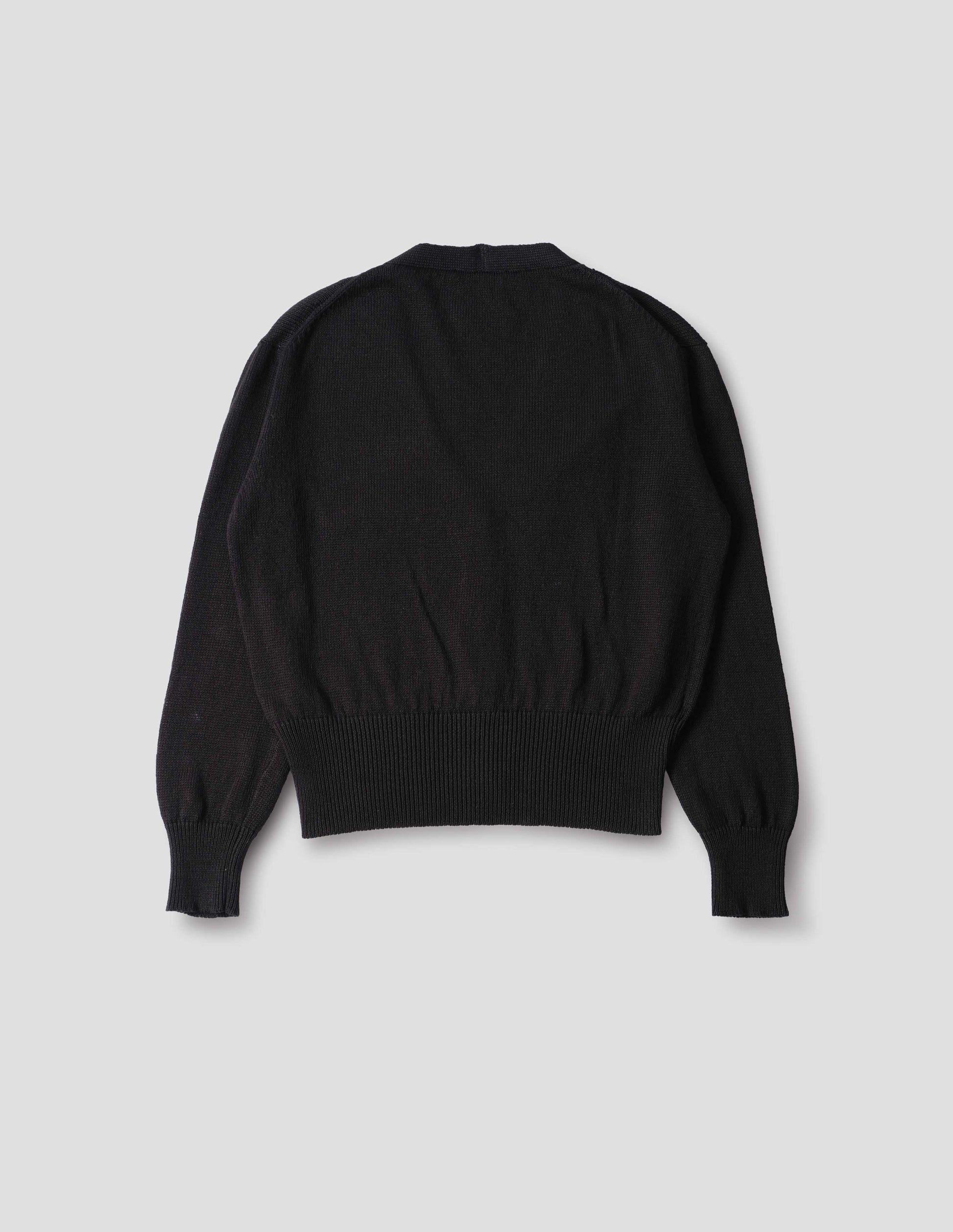 Black linen cotton cardigan with integral pockets and rib on neck, cuffs and wide hem. Back flat lay view.