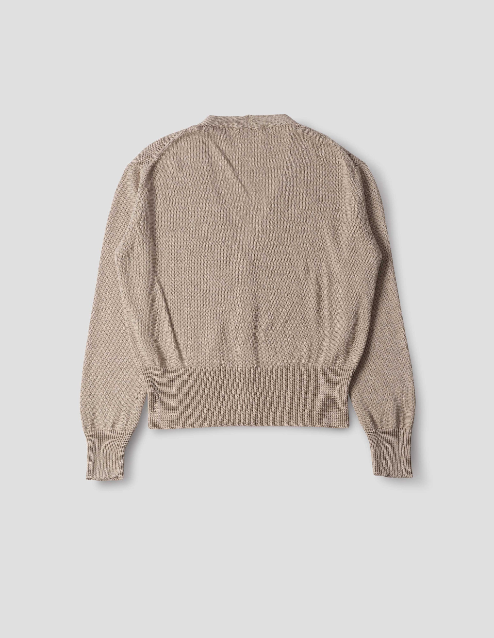 Beige linen cotton cardigan with integral pockets and rib on neck, cuffs and wide hem. Back flat lay view.