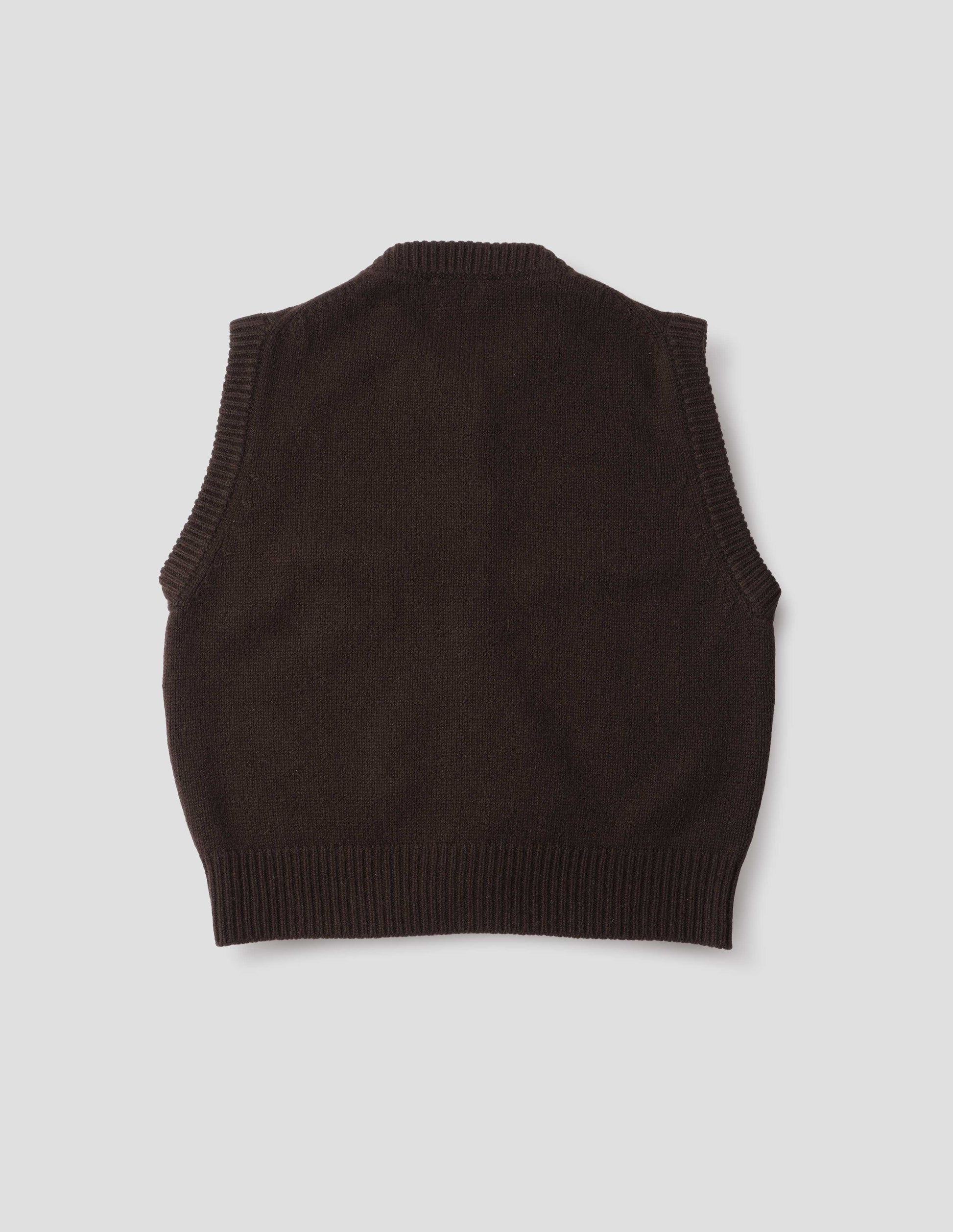 Dark brown sleeveless merino cashmere gilet with contrast rib neckline and hem.  Back flat lay view.