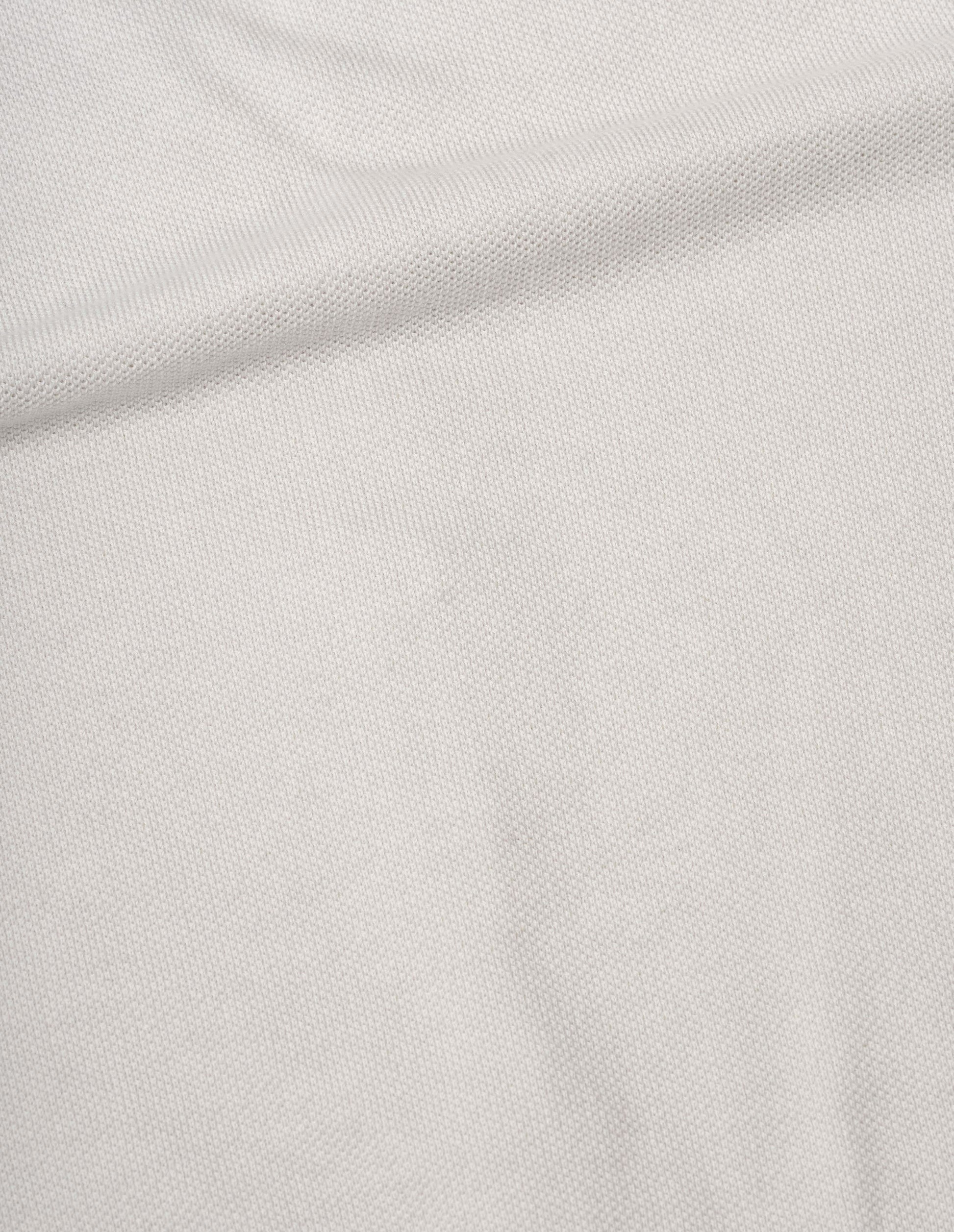 Off white short sleeve knitted light cotton shirt fabric swatch.