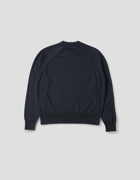 Dark navy merino wool and cotton long sleeve jumper with raglan sleeve, deep rib crew neck and single rib cuffs and hem. Back flat lay view.
