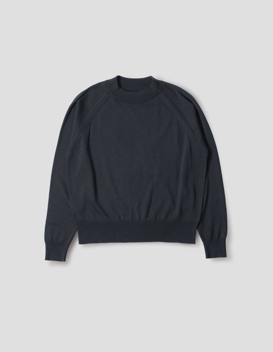 Dark navy merino wool and cotton long sleeve jumper with raglan sleeve, deep rib crew neck and single rib cuffs and hem. Front flat lay view.