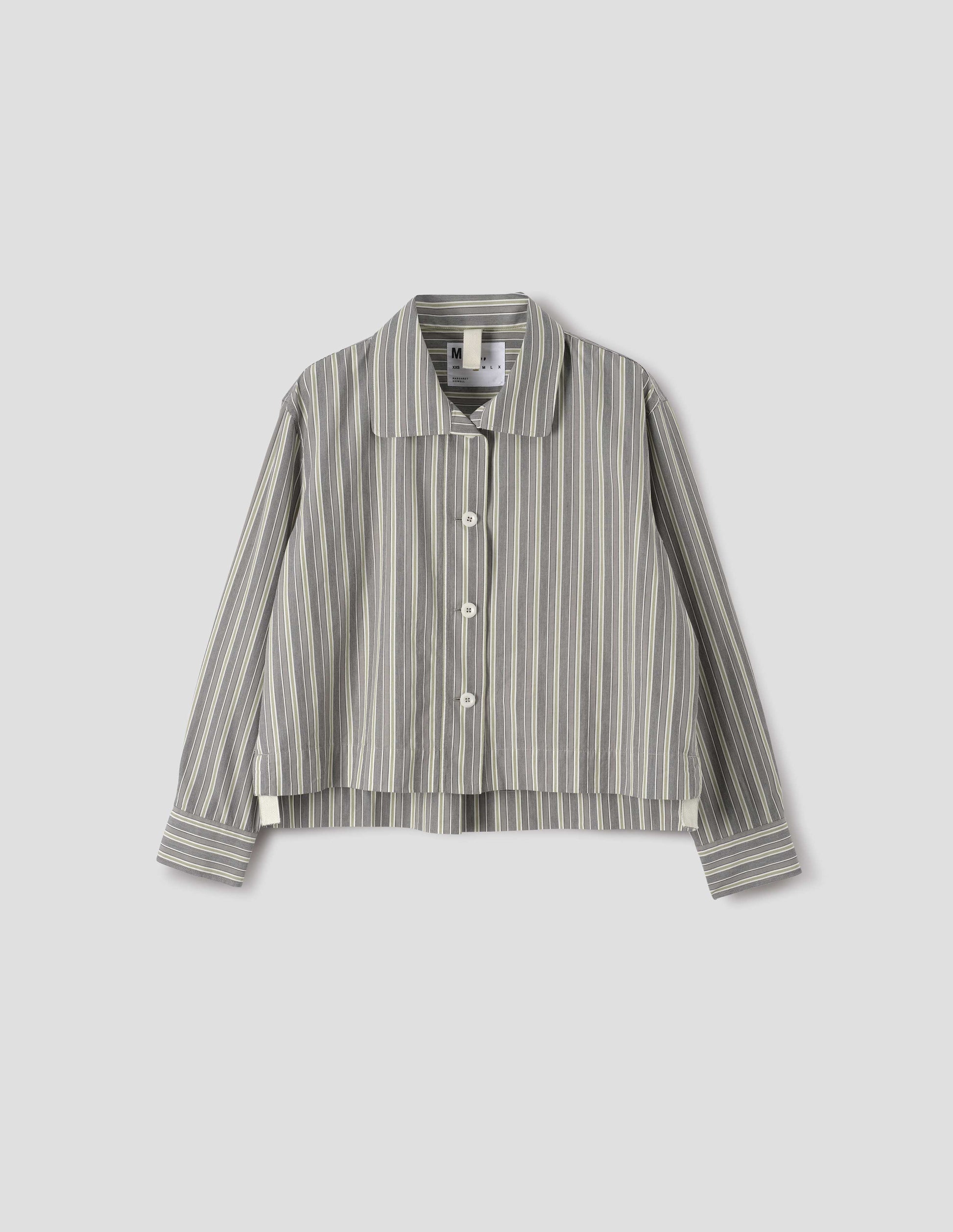 Grey, yellow and white striped cotton long sleeve shirt. With round collar, wide stitch through placket, stepped vent split hem and corozo brace button closure. Front flat lay view.