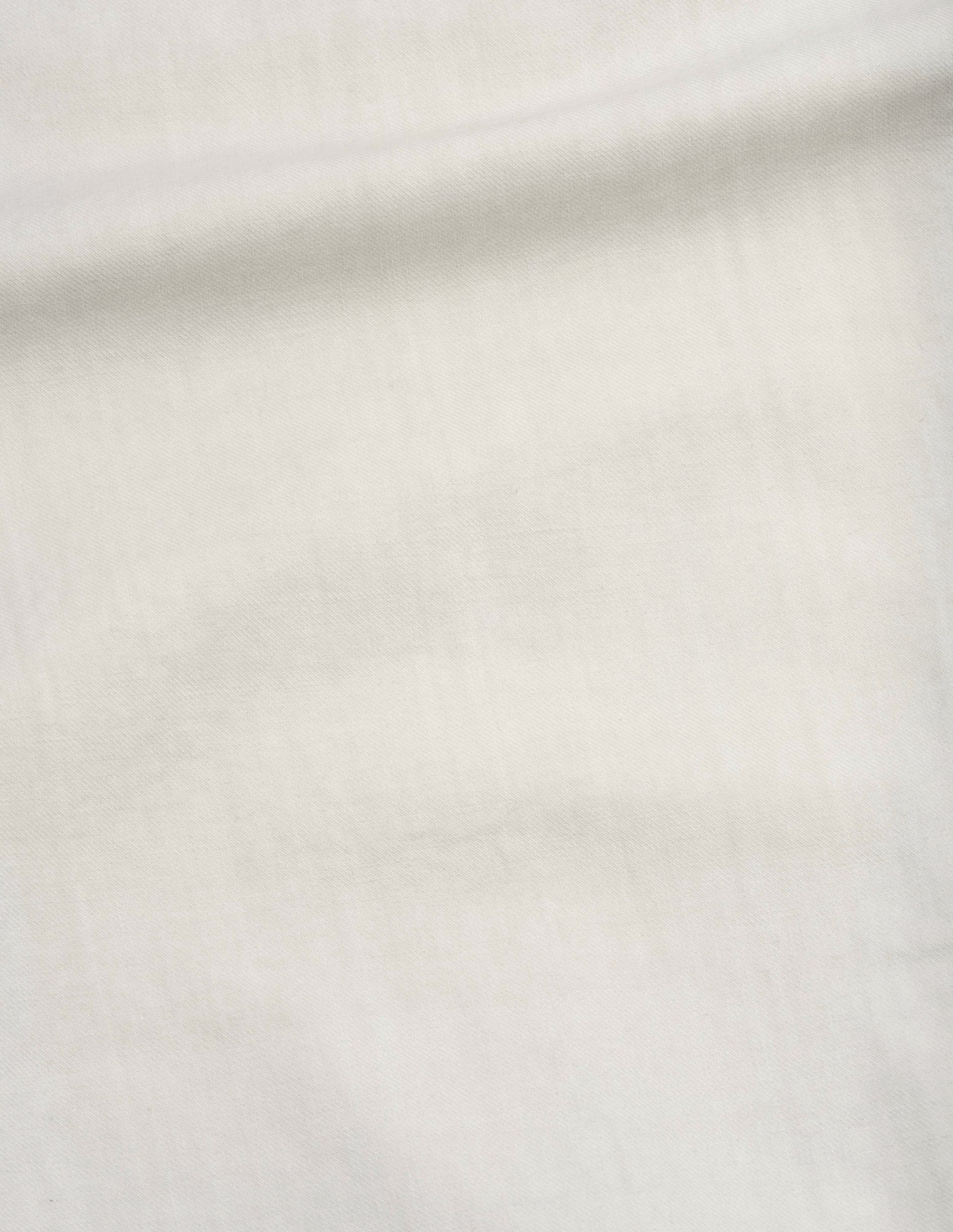 Beige irregular cotton drill button belt trousers, fabric swatch. 