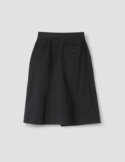 Black cotton twill skirt, with wide crossover waistband and stitch through welt back pocket. Back flat lay view.