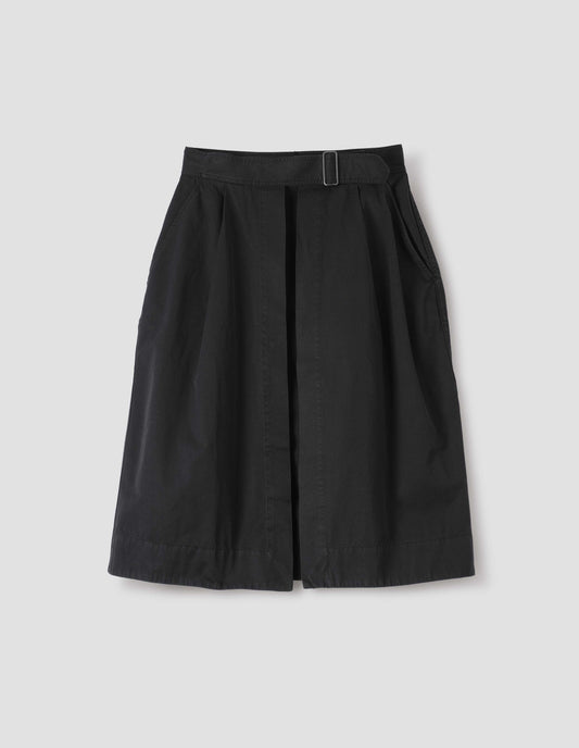 Black cotton twill skirt, with wide crossover waistband, button fastening slide adjuster and slant pockets. Front flat lay view.