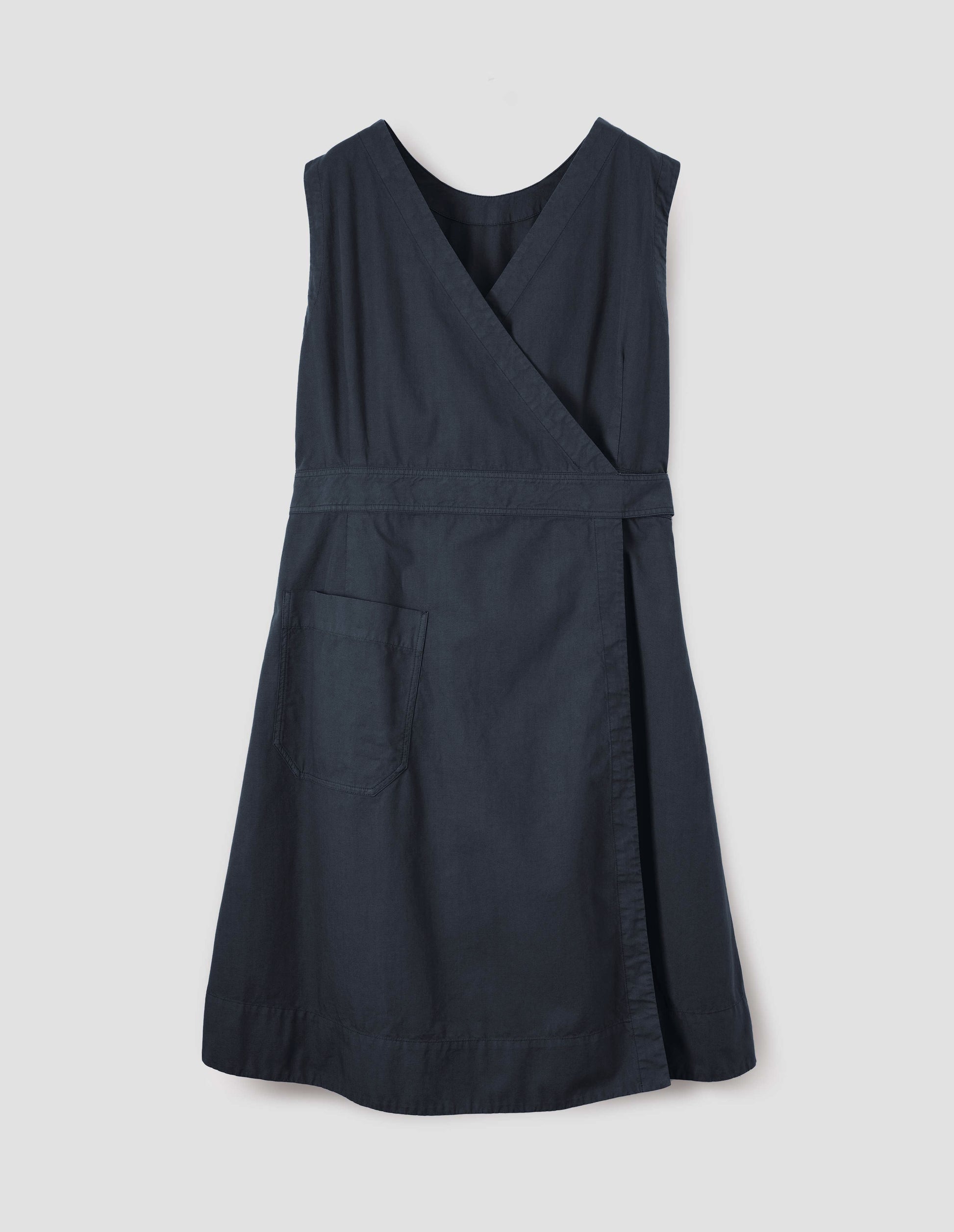 Dark navy cotton sleeveless dress with v detail on back, wrap around belt, back patch pocket and deep stitch hem. Back flat lay view.